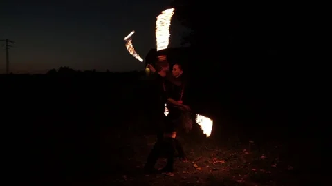 Young couple shows fire show outdoors. Stock Footage 81571478