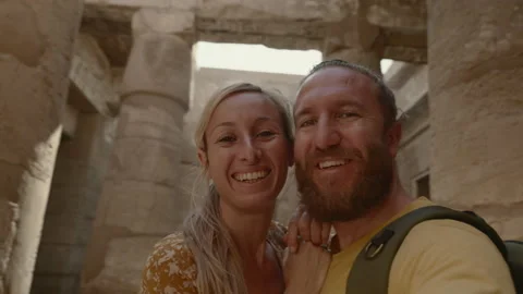 Young couple sightseeing ancient Egyptian temple take selfies Stock Footage 166415877