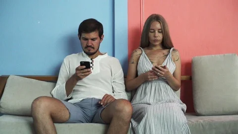 Young couple sit on couch use smartphones have rest together rapid slow motion Stock-Footage 88681252