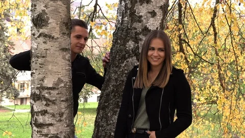 A young couple sits on a white bedspread in autumn park Vídeos de archivo 96210824
