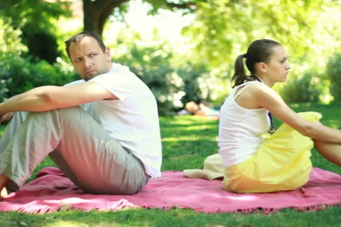Young couple sitting back to back having relationship difficulties Stock Footage 6524716