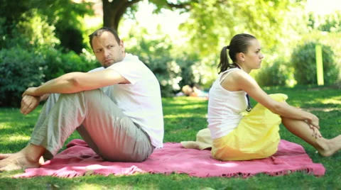 Young couple sitting back to back having relationship difficulties Stock Footage 6530386
