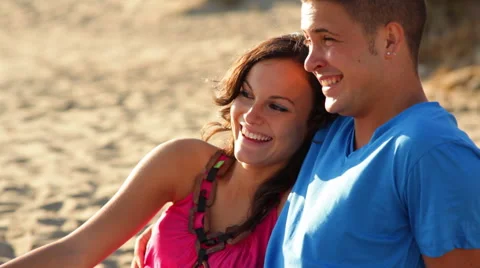 Young couple sitting on beach Video stock 43618068