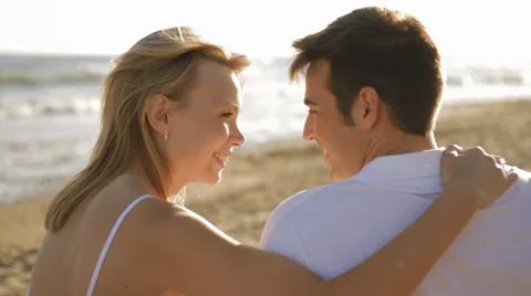 Young couple sitting on beach Stock Footage 43619238