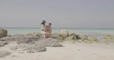 Young Couple Sitting on Beach Together, Romantic Tropical Vacation Stock Footage