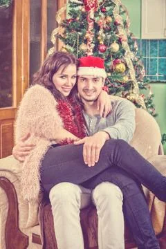 Young Couple Sitting in Chair in Their Home Stock Photos