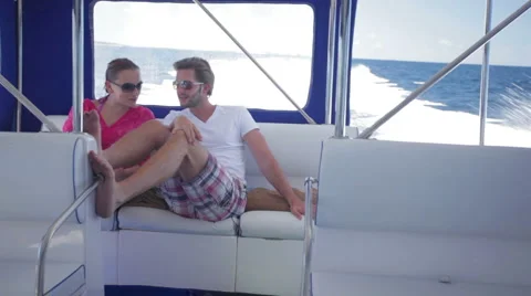 Young couple sitting close in speed boat Stock Footage 1008513