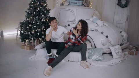 Young couple sitting down next to the tree are upset, at the end they both hug Video stock 143089757