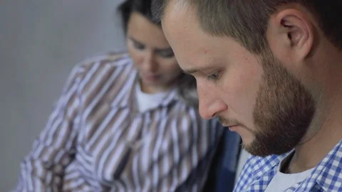 Young couple sitting on floor using tablet computer in their home. Stock Footage 128547912