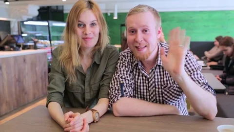 Young couple sitting in front of a computer and talk on Skype Stock-Footage 74489641