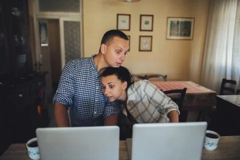 Young couple sitting in front of computers Stock Photos