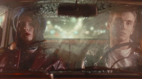 Young Couple Sitting Inside Retro Car during Rainy Night Drive Stock Footage 306365339