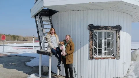 Young Couple sitting on the lighthouse. The Jack Russell Terrier. Stock-Footage 74952268