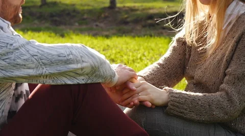 Young couple sitting in park Stock Footage 62697363