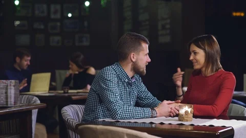 Young couple sitting in the restaurant Stock Footage 70443466