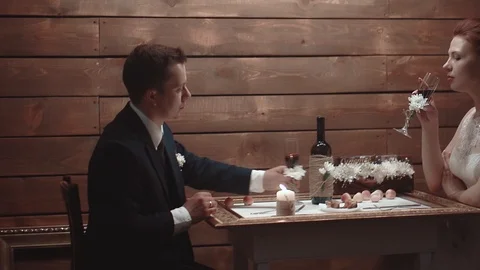 Young couple sitting in restaurant at table and drinking wine Stock Footage 105092721