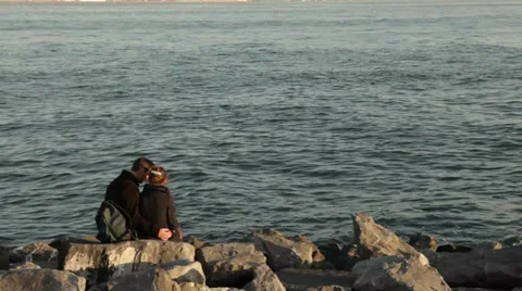 Young Couple sitting on Seashore Stock Footage 34524331