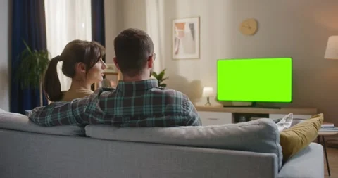 Young couple sitting at sofa. Man and woman relaxing at couch. Male and female Video stock 272215767
