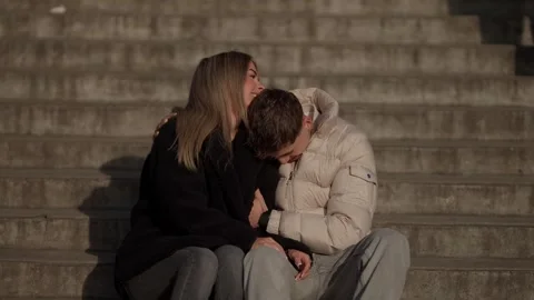Young couple sitting on steps in Paris France embracing and smiling at each Stock Footage 325267292