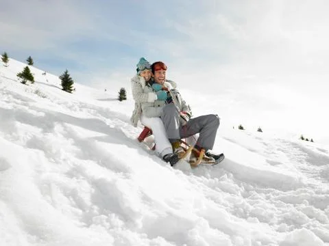 Young couple sledding Stock Photos