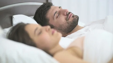 The young couple sleeping in the bed Stock Footage 76561206