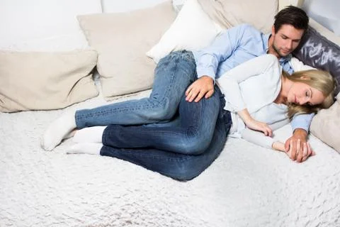Young couple sleeping on a couch Stock Photos