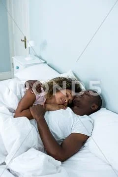 Young couple in love sleep together in bed. Stock Photo