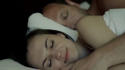Young couple sleeping together, focus on woman Stock Footage 1096007