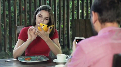 Young couple with smartphone sitting by table oat home HD Stock Footage 55357505