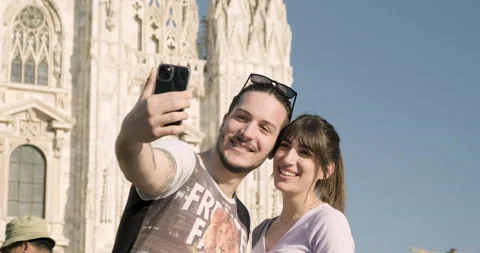 Young couple smiling and taking selfies at the Duomo square, Milan, Italy Stock Footage 172534406