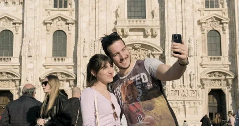 Young couple smiling and taking selfies at the Duomo square, Milan, Italy Stock Footage 172534604