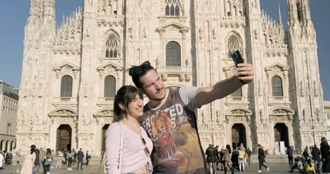 Young couple smiling and taking selfies at the Duomo square, Milan, Italy Stock Footage 172534720