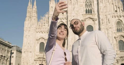 Young couple smiling and taking selfies at the Duomo square, Milan, Italy Stock Footage 172534724