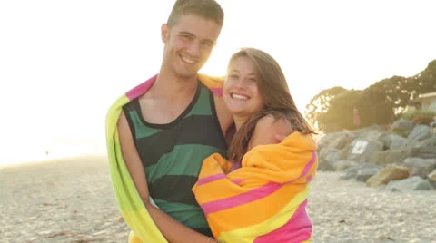 Young Couple Smiling at Camera on the Beach Stock Footage 24792525