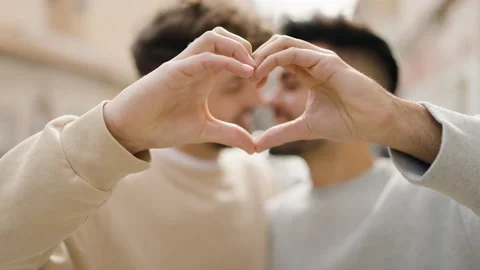 Young couple smiling confident doing heart symbol with hands at street Stock Footage 171039637