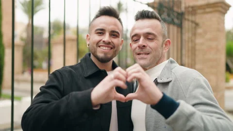 Young couple smiling confident doing heart symbol with hands at street Stock Footage 171815238