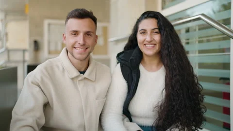 Young couple smiling confident sitting on stairs speaking at street Stock Footage 172054785
