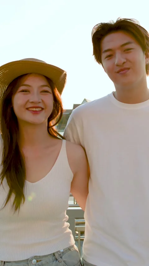 Young Couple Smiling by Riverside at Sunset in Bangkok Stockbeeldmateriaal 323434389