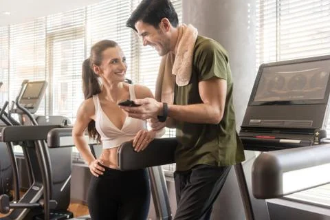 Young couple smiling while communicating on the mobile phone dur Fotos Stock