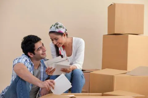 Young couple smiling while looking at photographs Stock Photos