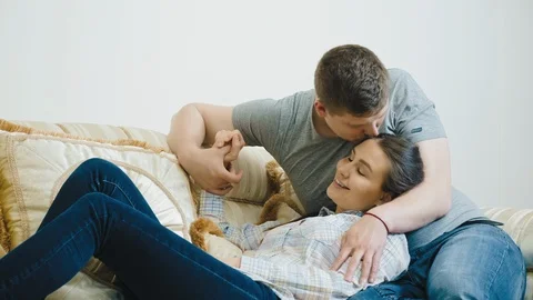 Young couple on the sofa in love Stock Footage 106504646