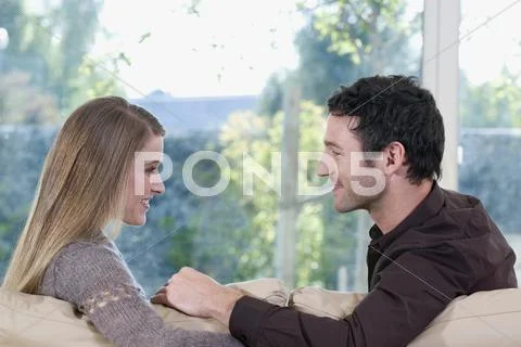 Young couple on sofa Stock Photos