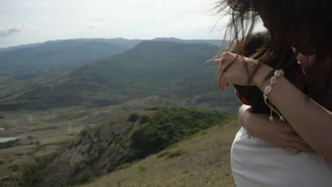 Young couple spend time in the mountains strong wind develops hair 스톡 동영상 146719908