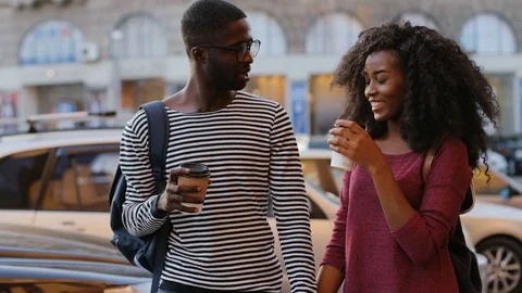 Young couple spending time together, drinking coffee in paper cups and talking Stock Footage 81838665