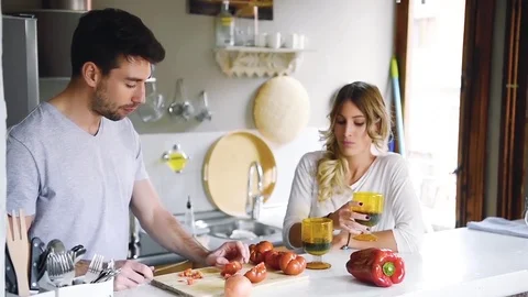 Young couple st home kitchen cooking and drinking wine. Stock Footage 74728583