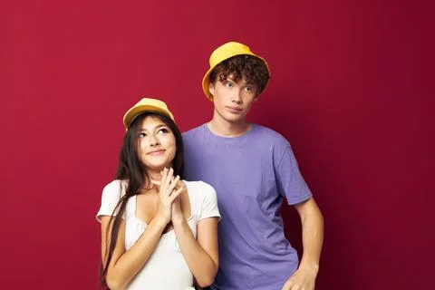 A young couple stand side by side fashion modern style home fun isolated Stock Photos