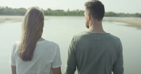 Young couple standing backwards Stock Footage 99342077