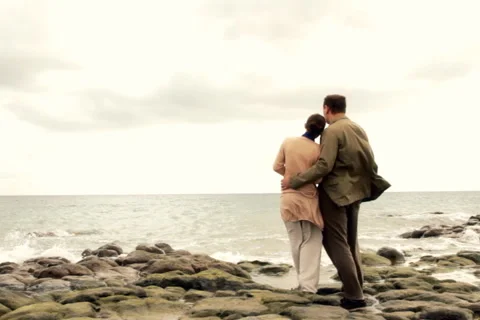 Young couple standing on the seashore, back view Stock Footage 1051301
