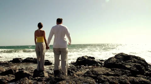 Young couple standing on the seashore, back view Stock Footage 1095957