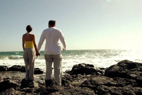 Young couple standing on the seashore, back view Stock Footage 1095980